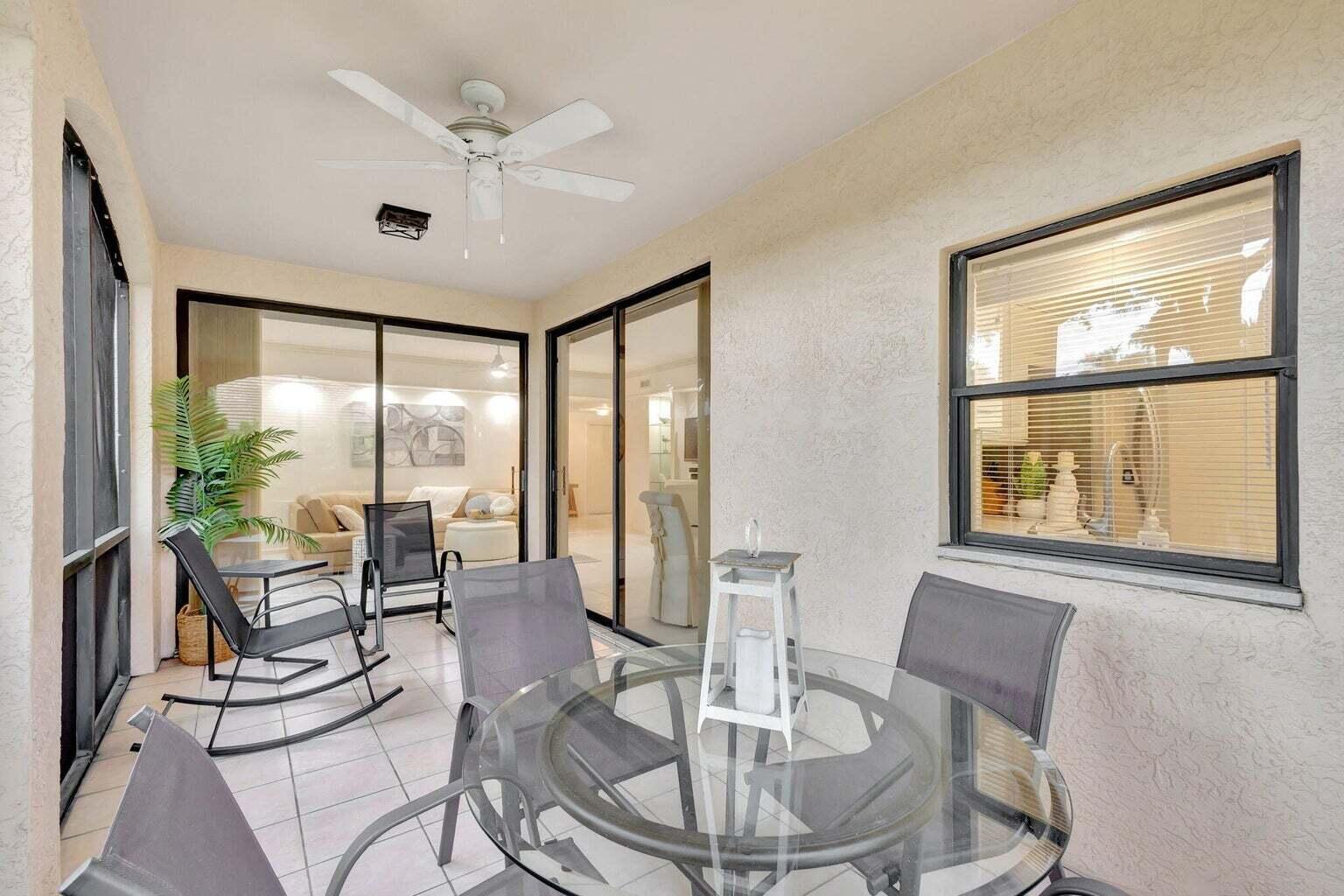 16151 West Bay Drive, Unit 161 Jupiter, FL 33477 - Photo 25 of 25 a dining room with furniture a chandelier and a large window