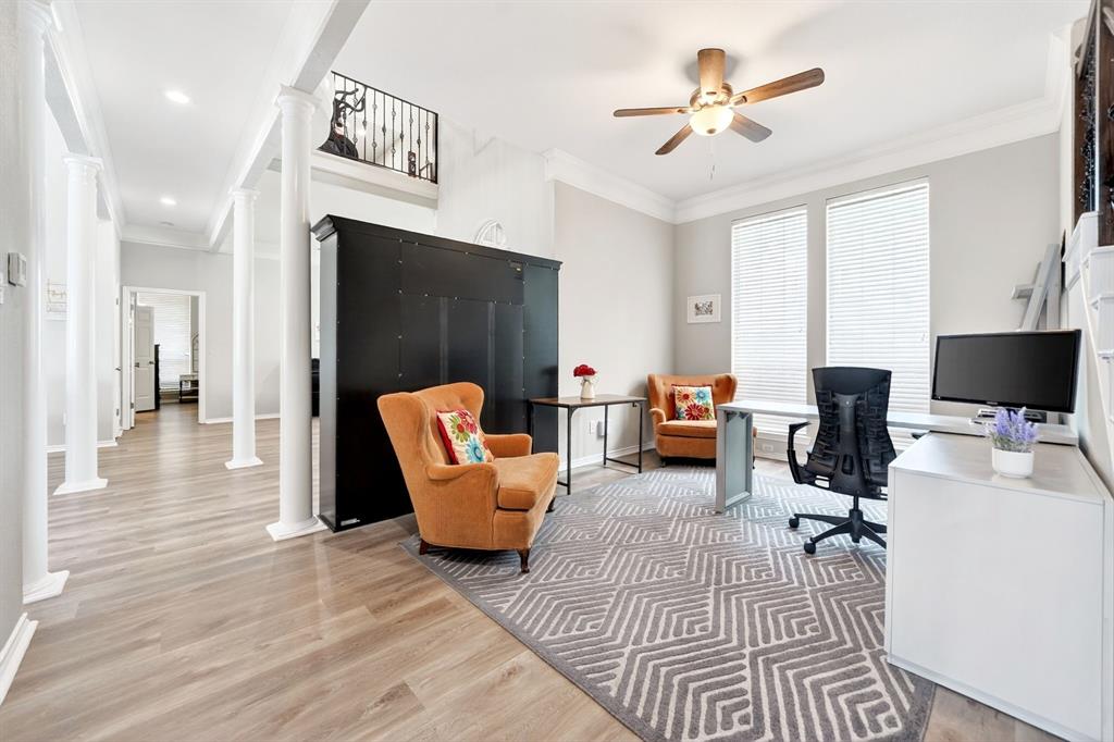 4509 Scenic Drive Rowlett, TX 75088 - Photo 7 of 40 Open-concept living area featuring light wood-finish flooring, white architectural columns, and a large area rug