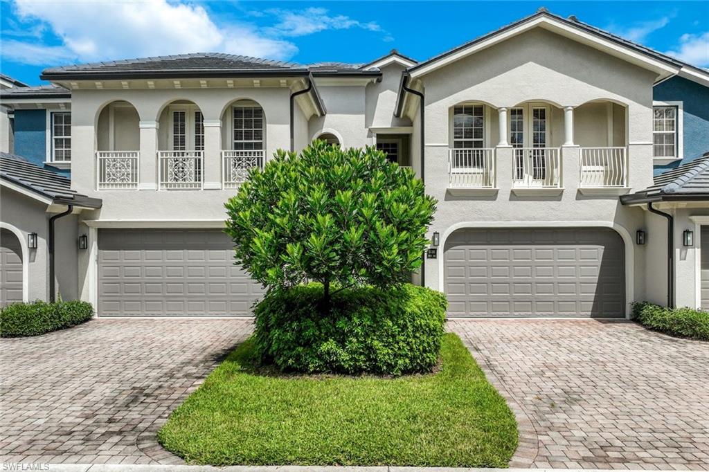 3530 Lansing Loop, Unit 202 Estero, FL 33928 - Photo 11 of 35 a front view of a house with garden