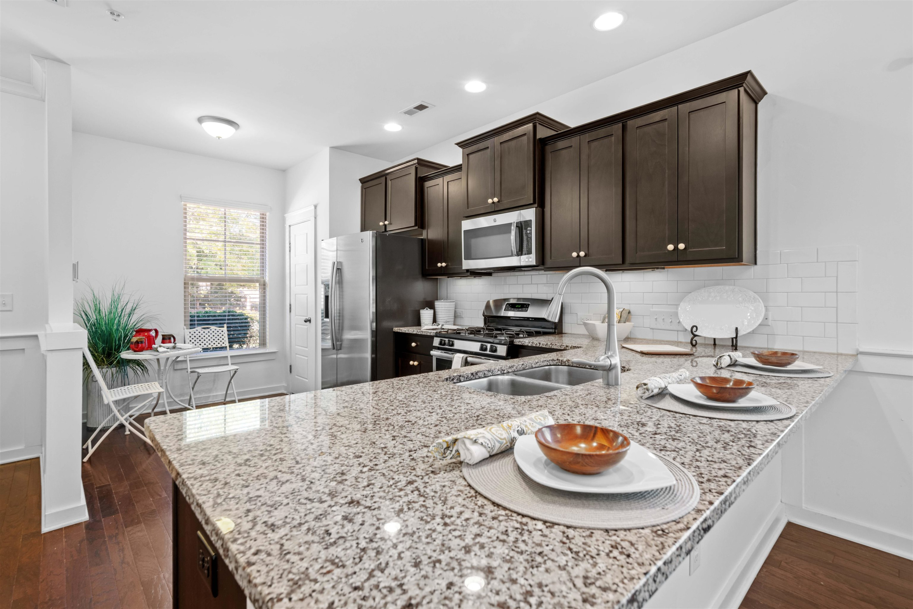7922 Allscott Way Raleigh, NC 27612 - Photo 1 of 28 a kitchen with granite countertop wooden cabinets and a sink