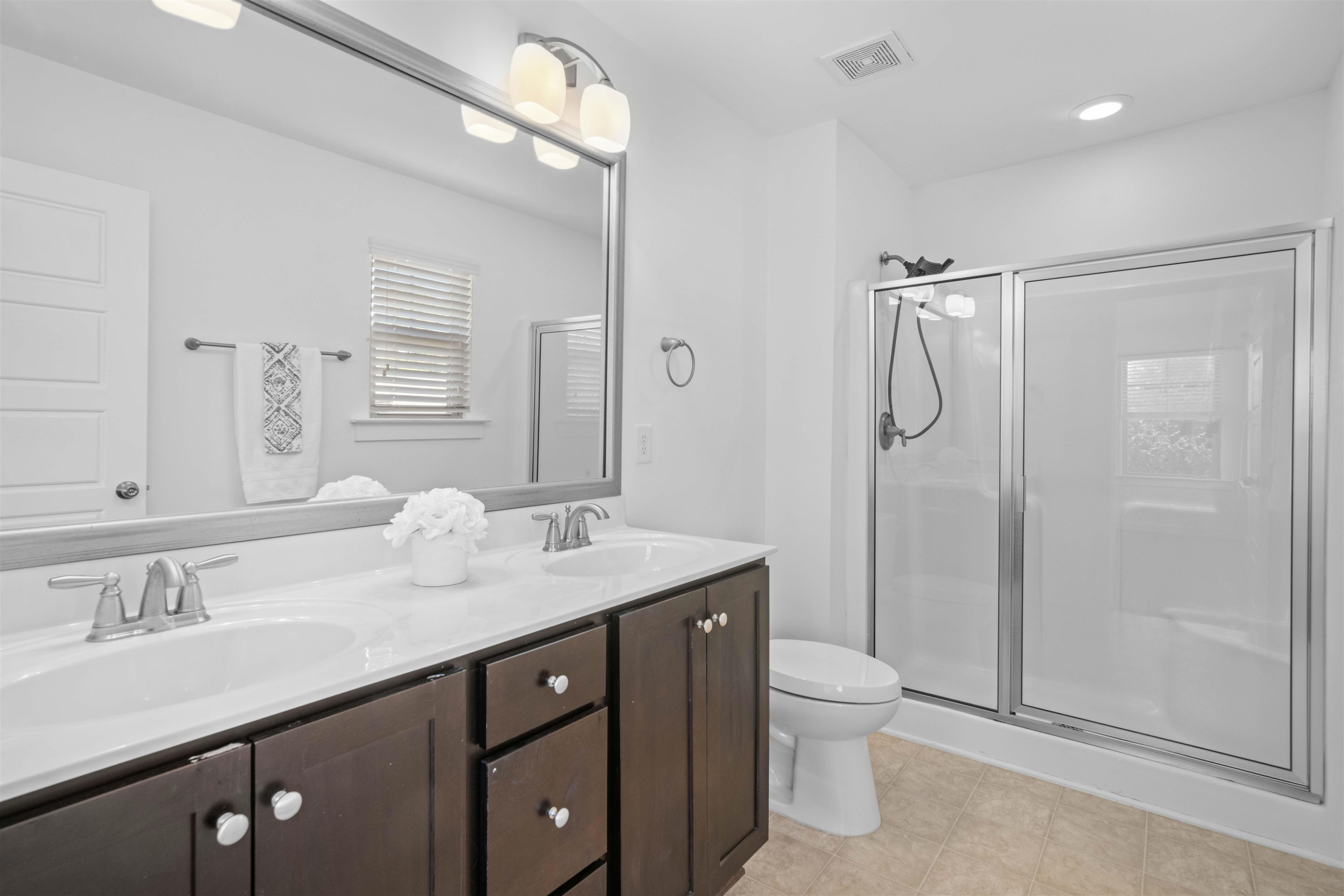 7922 Allscott Way Raleigh, NC 27612 - Photo 18 of 28 a bathroom with a granite countertop sink toilet a mirror and shower