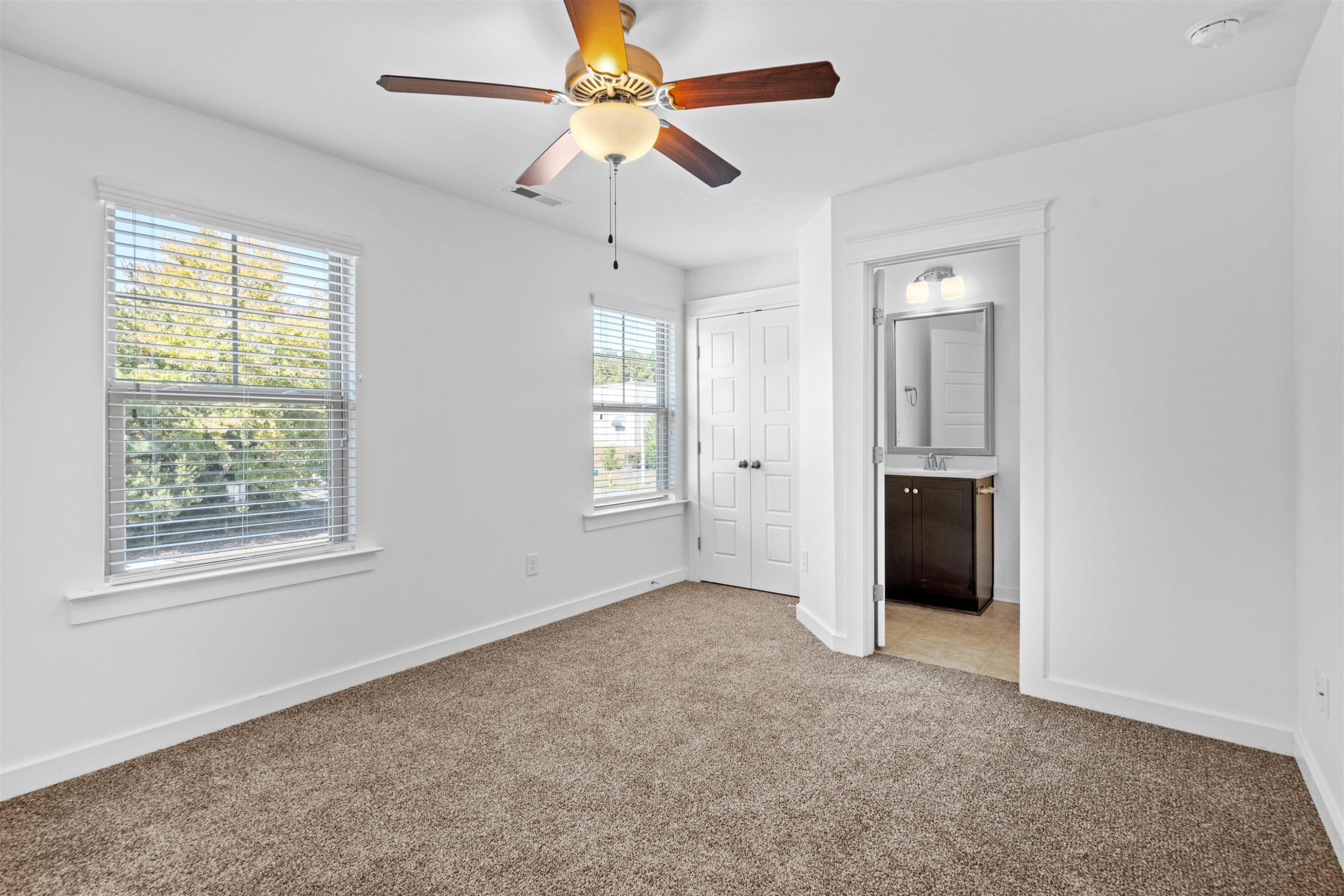 7922 Allscott Way Raleigh, NC 27612 - Photo 21 of 28 an empty room with chandelier fan and windows