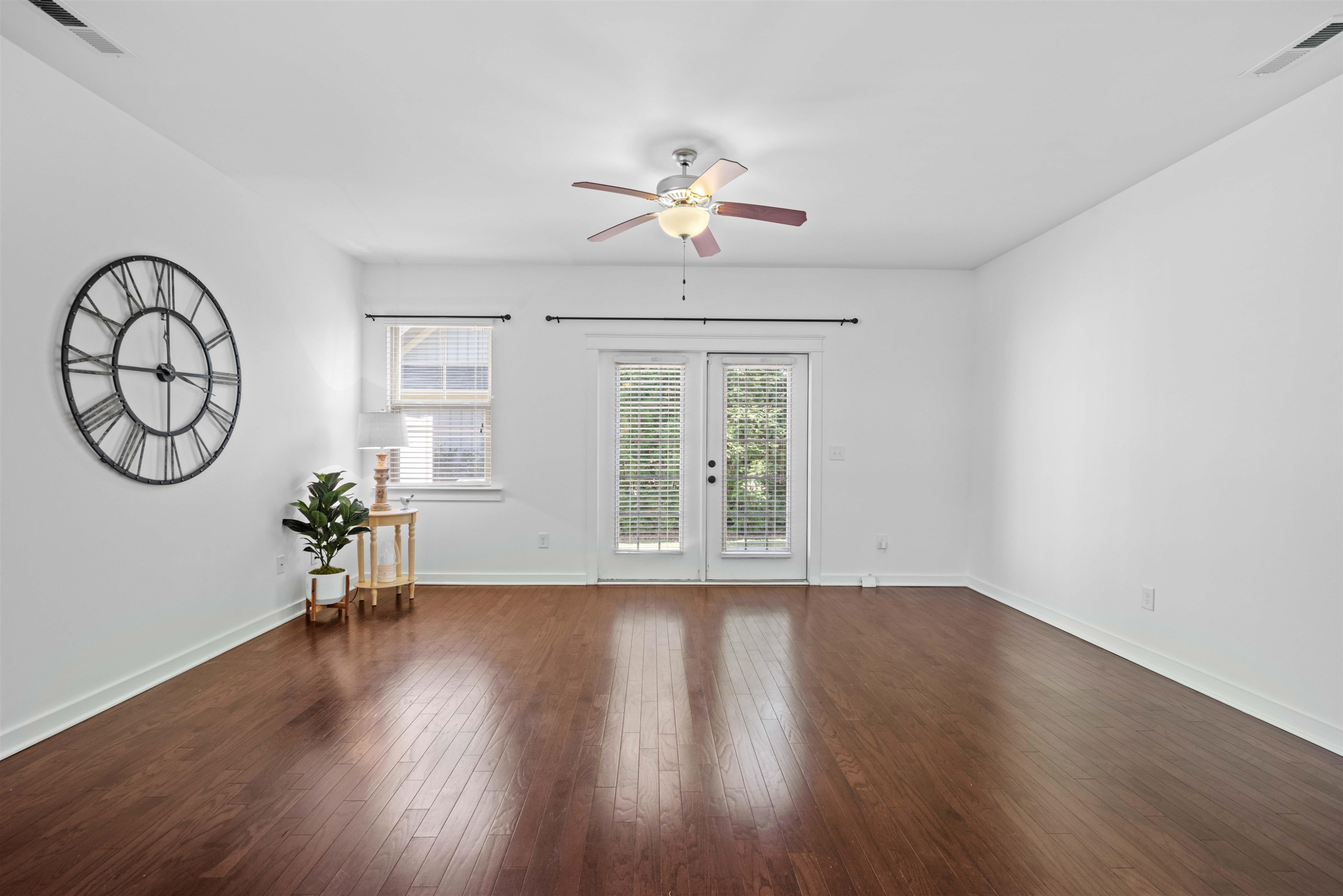 7922 Allscott Way Raleigh, NC 27612 - Photo 5 of 28 a view of a room with wooden floor fan and windows
