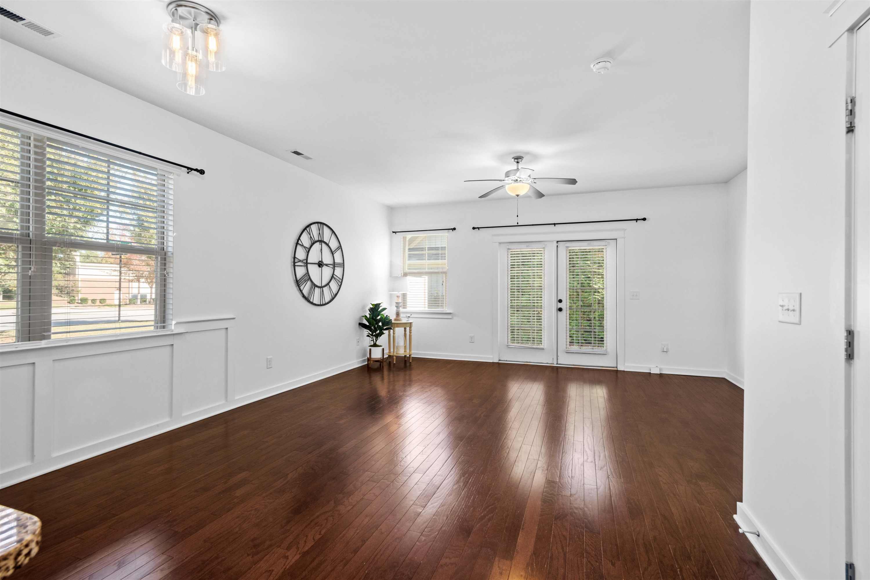 7922 Allscott Way Raleigh, NC 27612 - Photo 6 of 28 a view of an empty room with wooden floor and a window