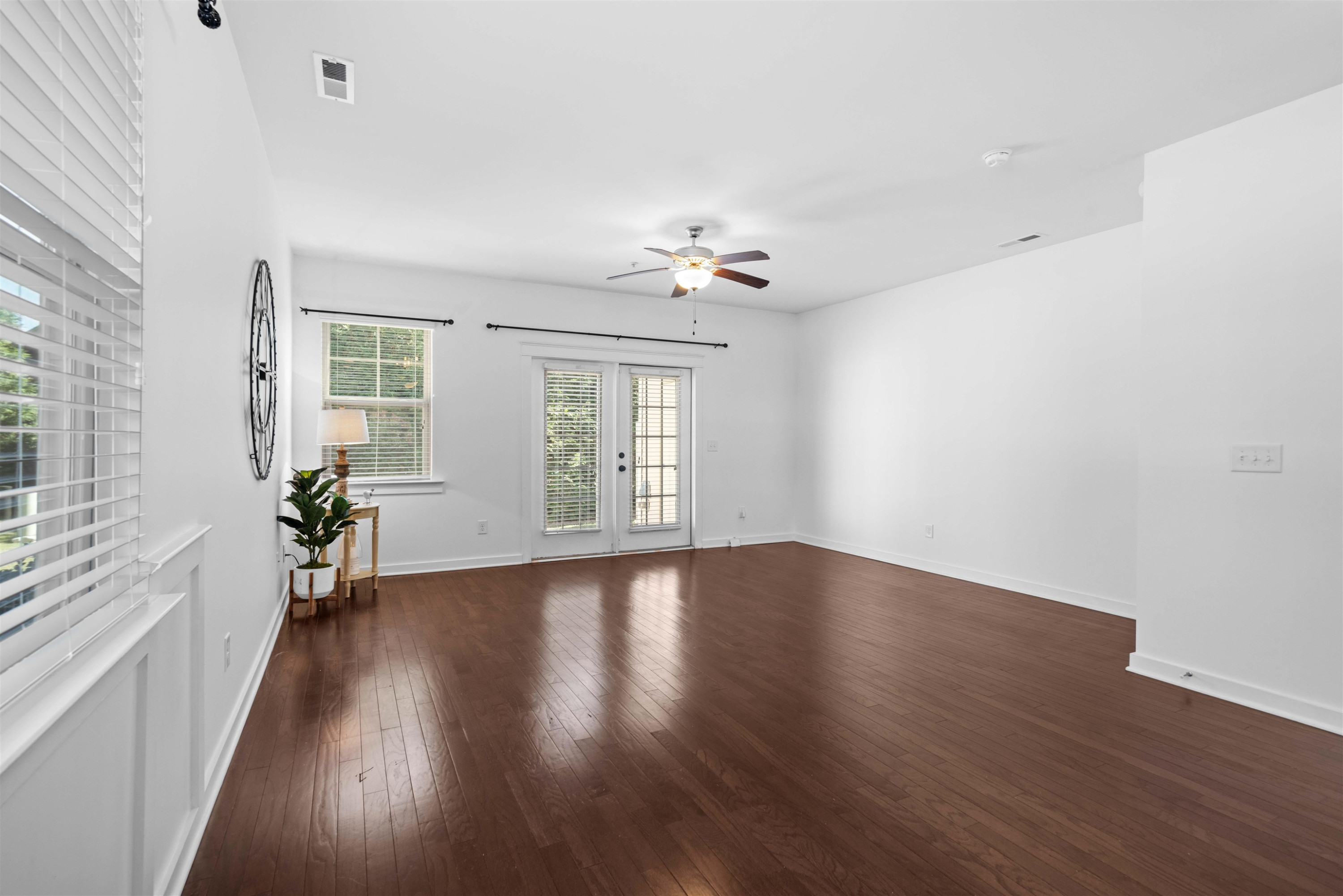 7922 Allscott Way Raleigh, NC 27612 - Photo 8 of 28 an empty room with wooden floor and windows