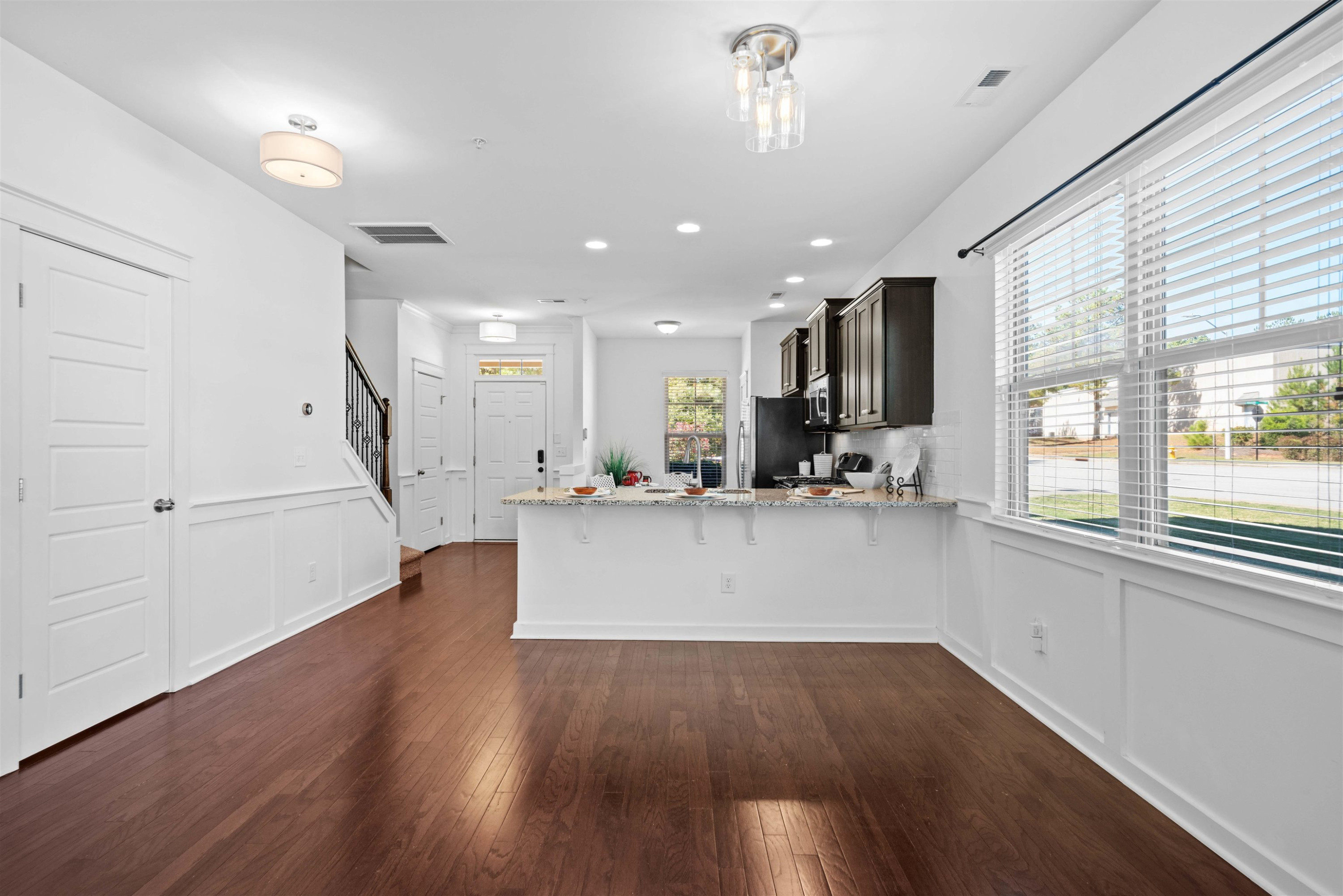 7922 Allscott Way Raleigh, NC 27612 - Photo 9 of 28 a view of kitchen with cabinets and wooden floor