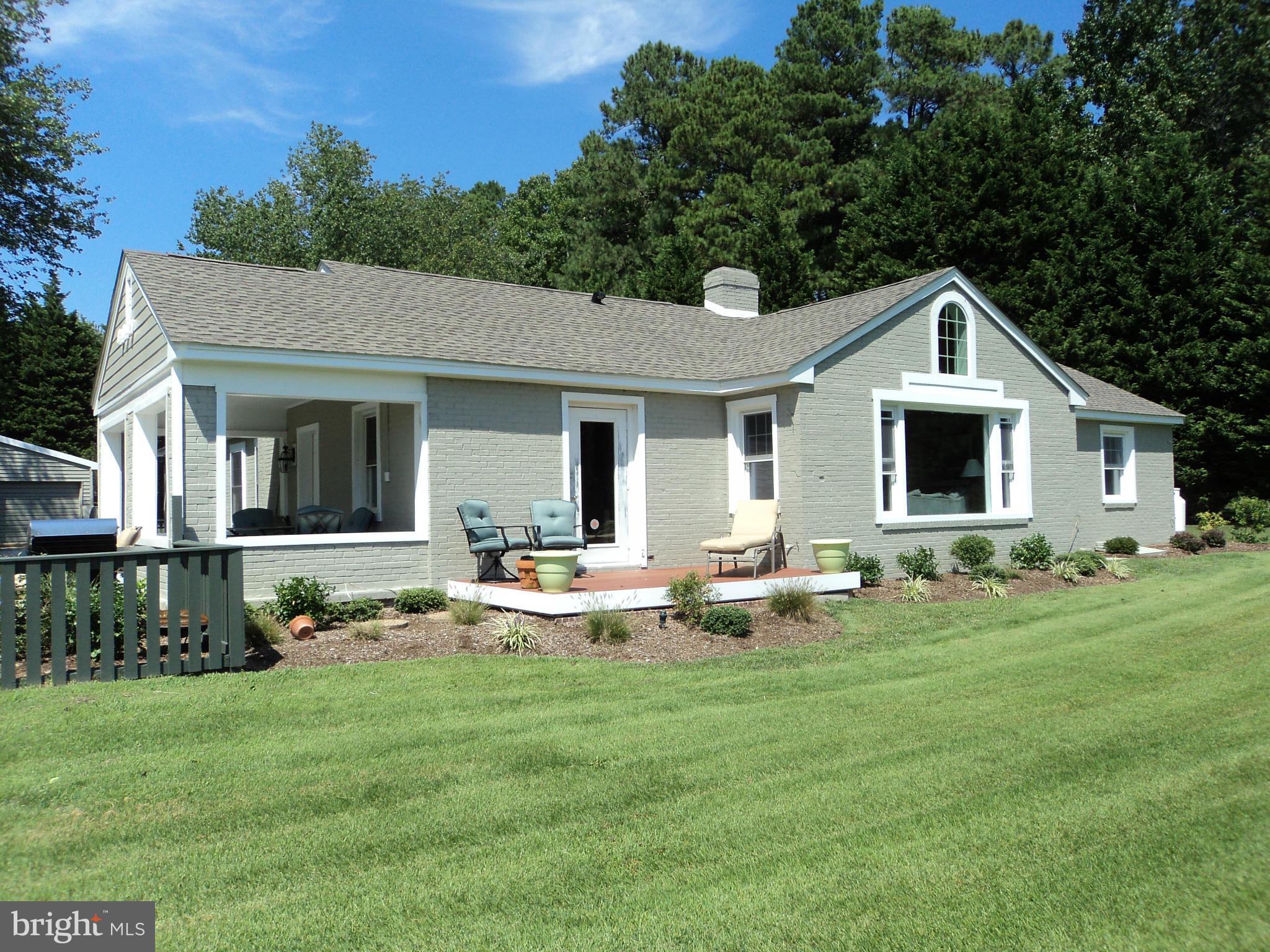 6871 Edge Creek Road St. Michaels, MD 21663 - Photo 1 of 26 a front view of a house with garden and porch