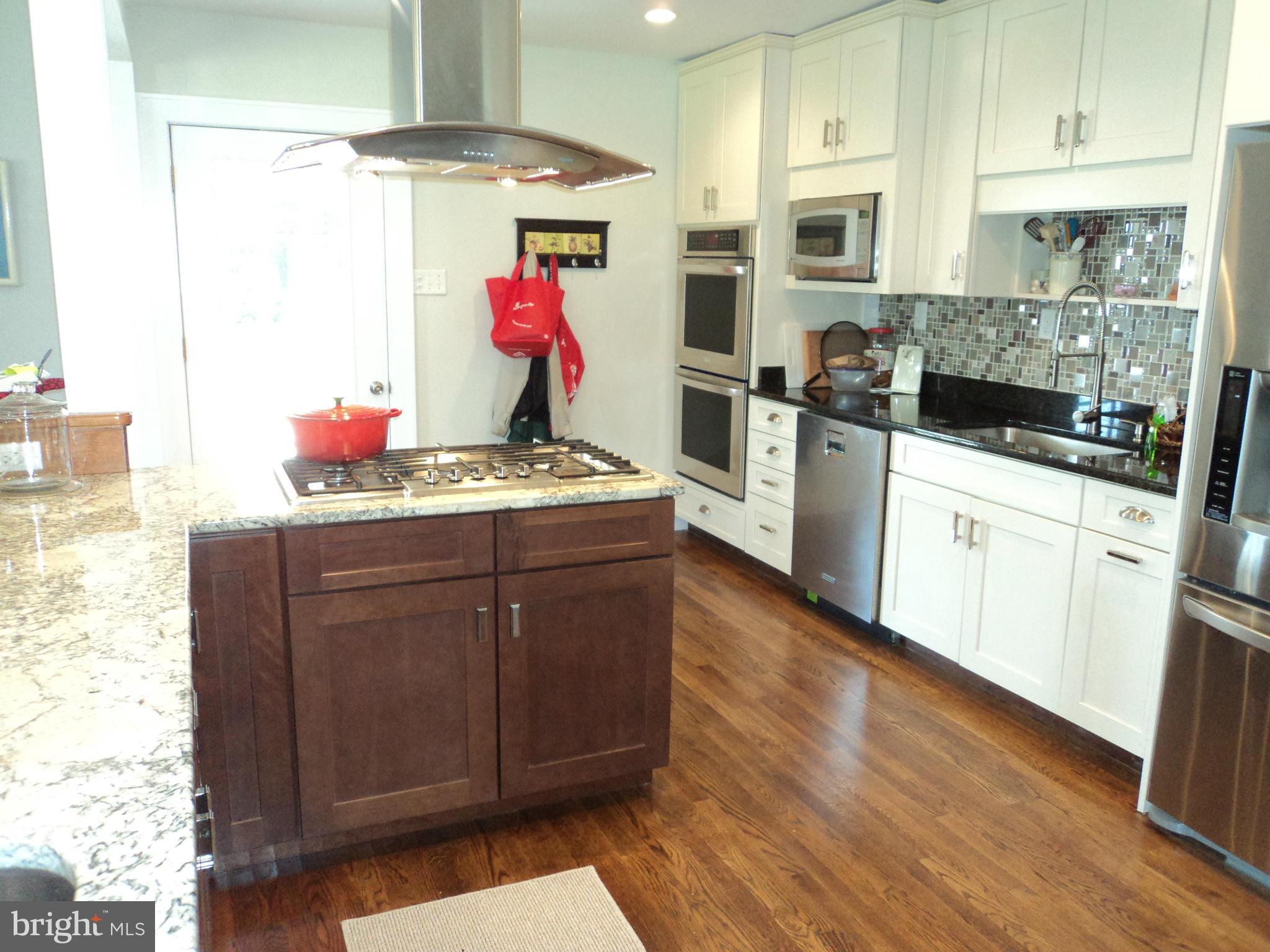6871 Edge Creek Road St. Michaels, MD 21663 - Photo 12 of 26 a kitchen with a sink cabinets and wooden floor