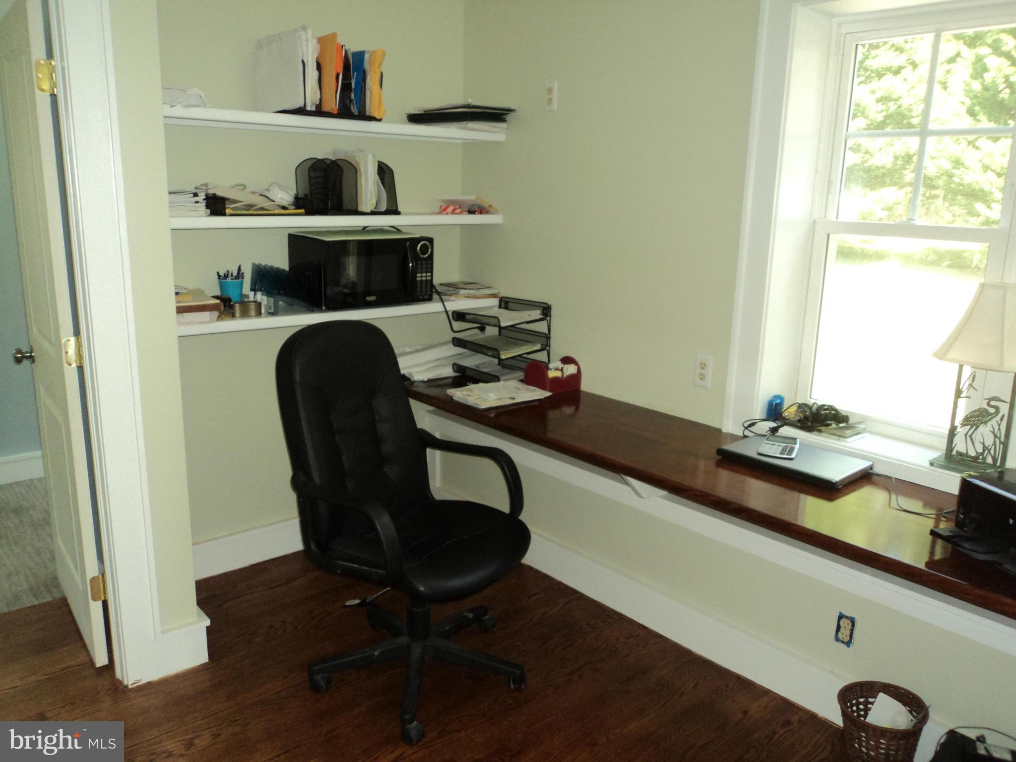 6871 Edge Creek Road St. Michaels, MD 21663 - Photo 22 of 26 a view of a workspace with furniture and a window
