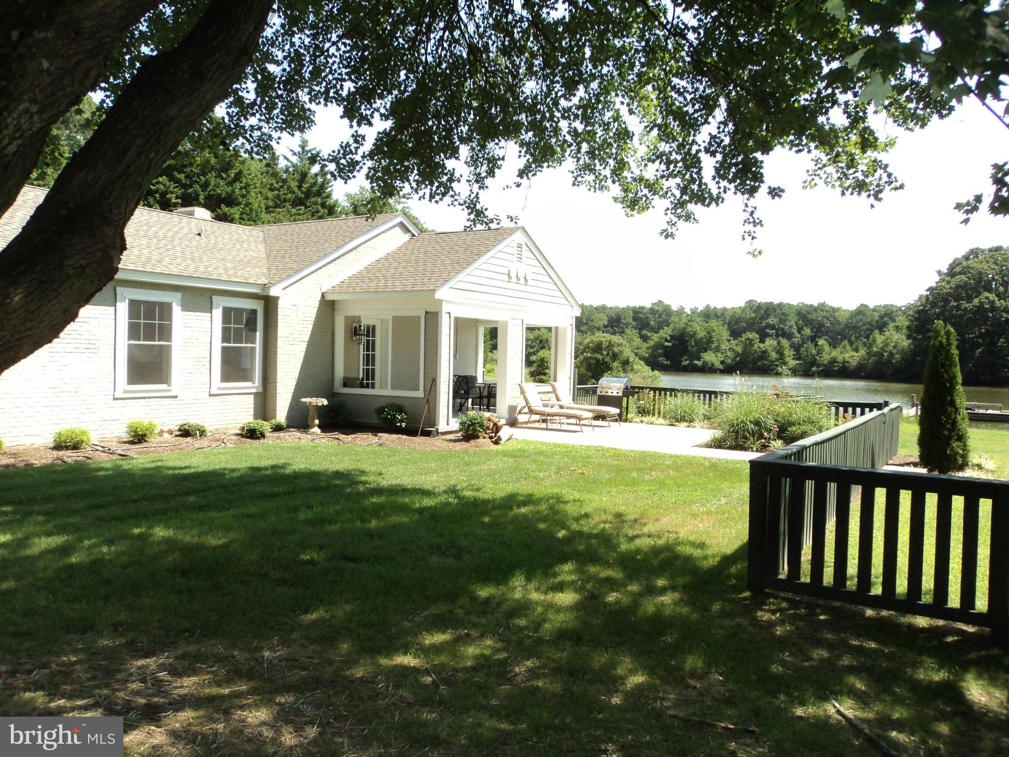 6871 Edge Creek Road St. Michaels, MD 21663 - Photo 24 of 26 a front view of a house with a garden