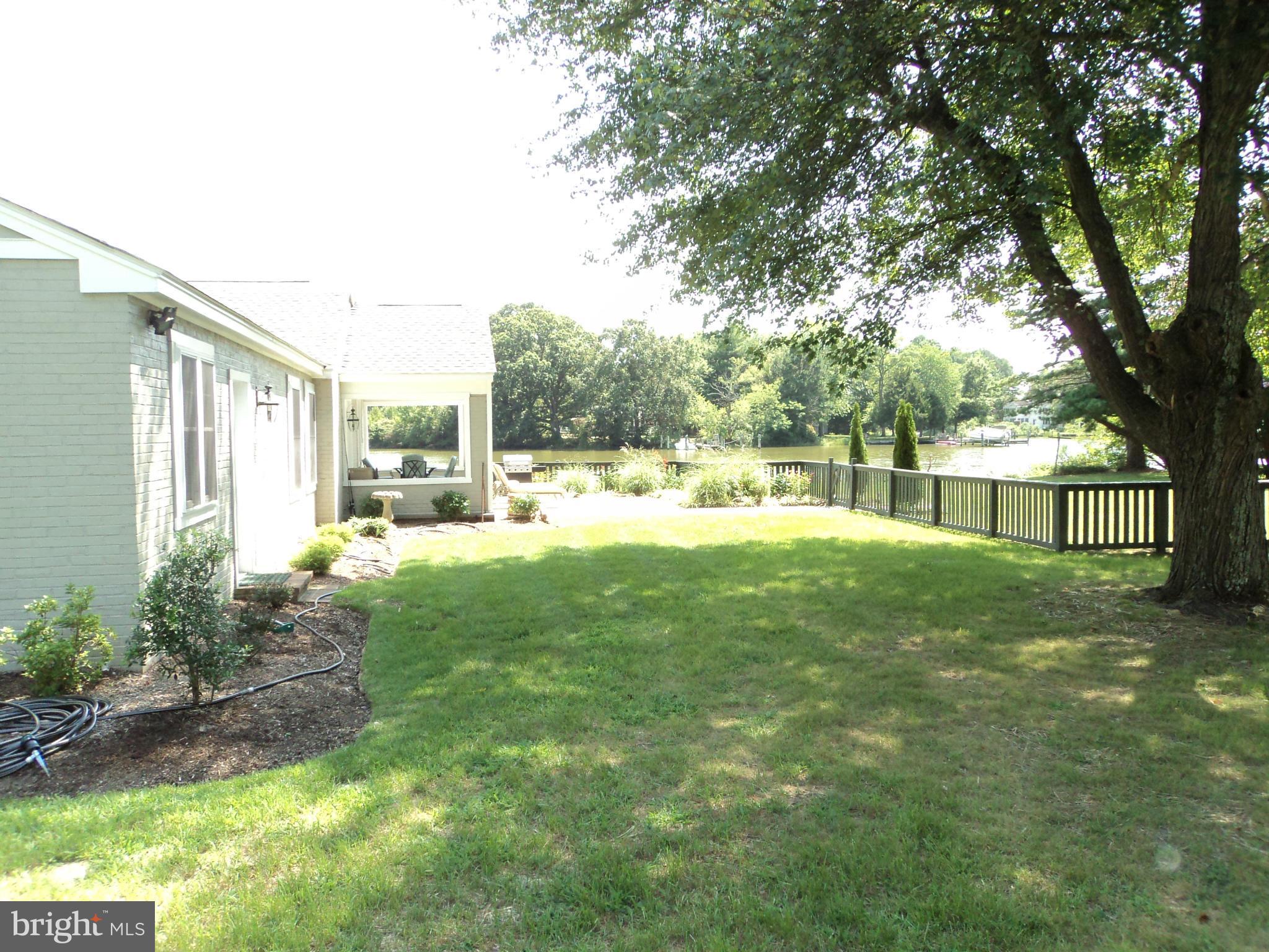 6871 Edge Creek Road St. Michaels, MD 21663 - Photo 6 of 26 a view of a yard and front view of a house