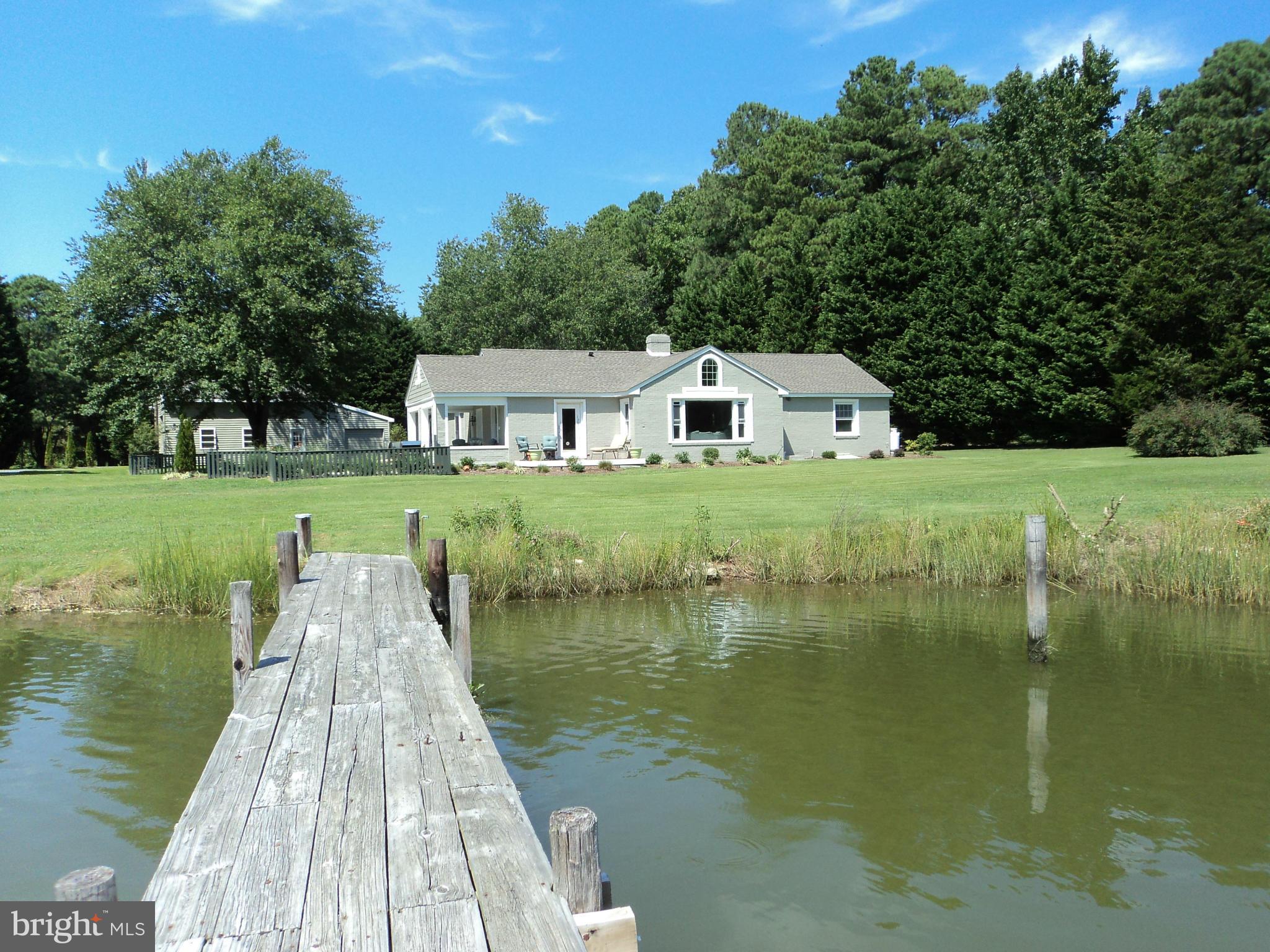 6871 Edge Creek Road St. Michaels, MD 21663 - Photo 10 of 26 a view of a lake with a house in the background