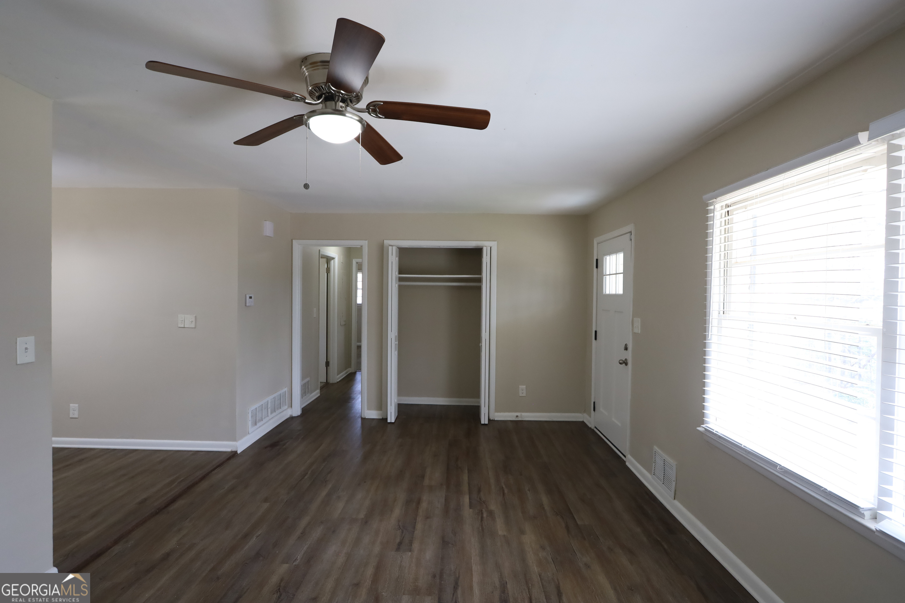 1751 Woodsloe Drive Decatur, GA 30035 - Photo 3 of 9 a view of empty room with wooden floor and fan