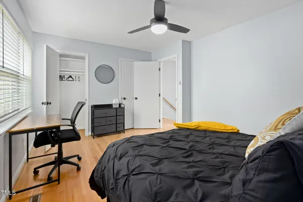 a bedroom with a bed a desk and chair