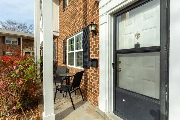 a view of a door with a couple of chairs and a outdoor space