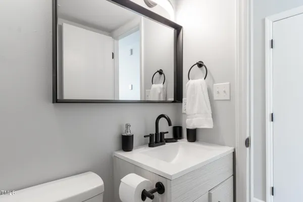 a bathroom with a toilet sink and mirror