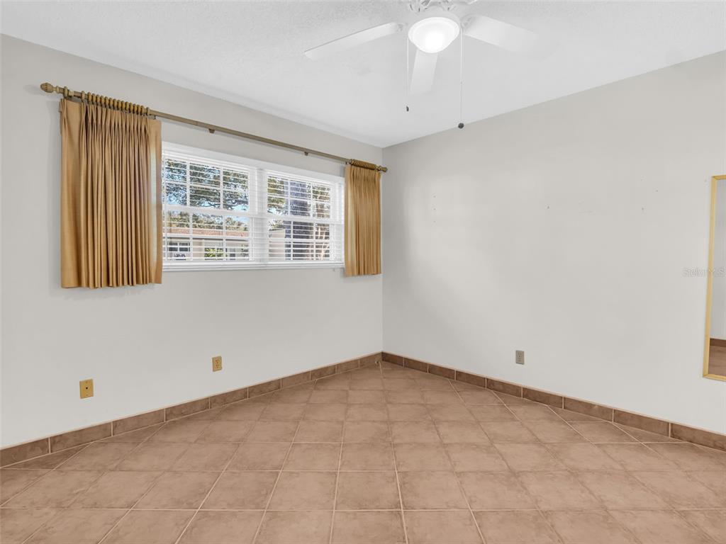 3109 Mission Grove Drive, Unit D Palm Harbor, FL 34684 - Photo 17 of 62 an empty room with a window