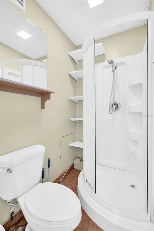 3109 Mission Grove Drive, Unit D Palm Harbor, FL 34684 - Photo 18 of 62 a white toilet sitting next to a bathroom sink