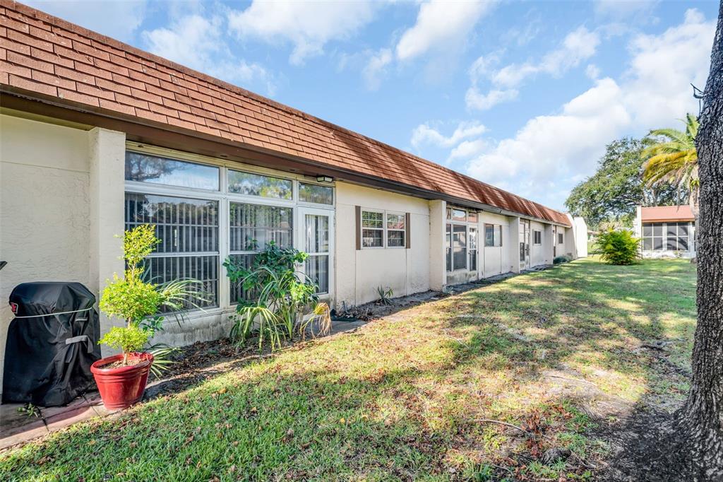 3109 Mission Grove Drive, Unit D Palm Harbor, FL 34684 - Photo 27 of 62 a view of a house with backyard and sitting area
