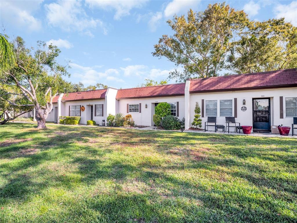 3109 Mission Grove Drive, Unit D Palm Harbor, FL 34684 - Photo 28 of 62 a front view of a house with a garden