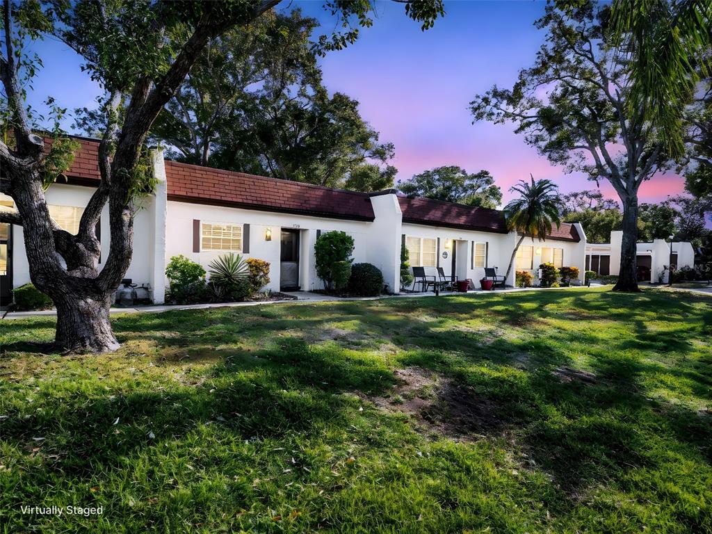 3109 Mission Grove Drive, Unit D Palm Harbor, FL 34684 - Photo 3 of 62 a house view with a garden space