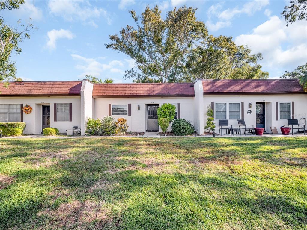 3109 Mission Grove Drive, Unit D Palm Harbor, FL 34684 - Photo 39 of 62 a front view of a house with a garden