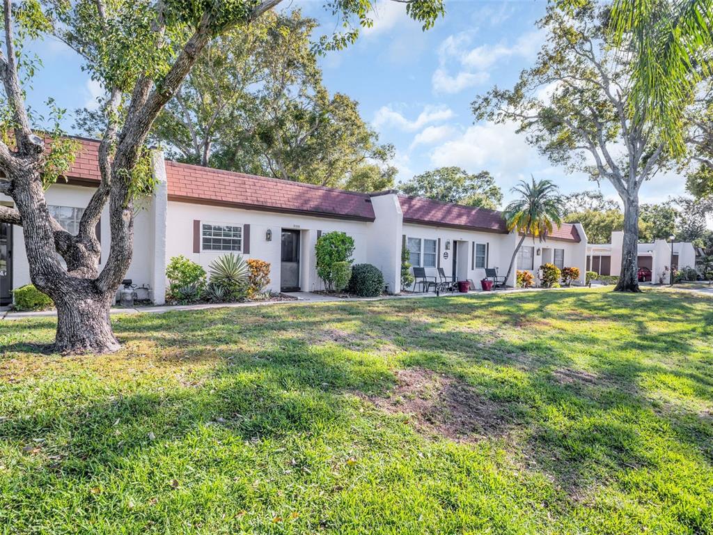 3109 Mission Grove Drive, Unit D Palm Harbor, FL 34684 - Photo 40 of 62 a front view of house with yard and green space
