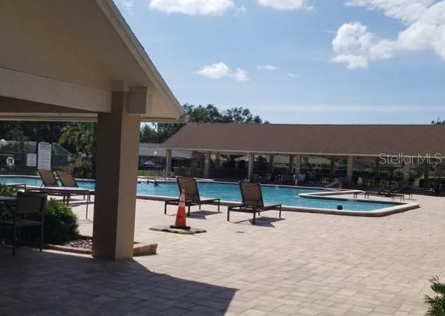 3109 Mission Grove Drive, Unit D Palm Harbor, FL 34684 - Photo 50 of 62 a view of a swimming pool with seating space