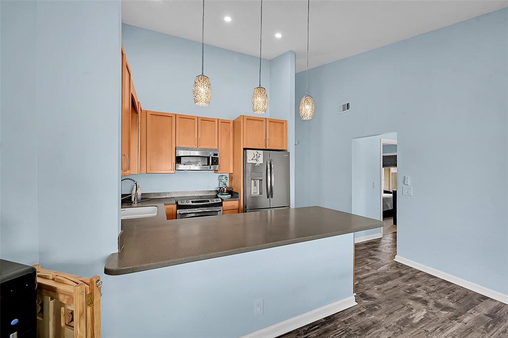 22533 Swordfish Drive Boca Raton, FL 33428 - Photo 14 of 49 a kitchen with stainless steel appliances granite countertop a sink a stove and a refrigerator