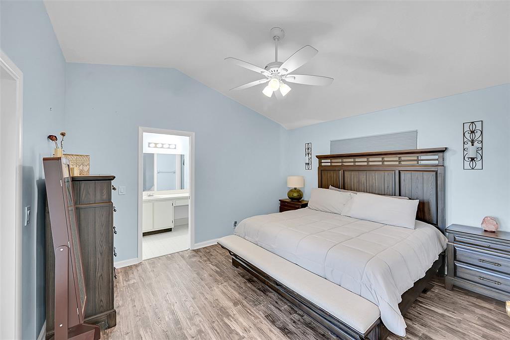 22533 Swordfish Drive Boca Raton, FL 33428 - Photo 17 of 49 a bedroom with a large bed and a chandelier