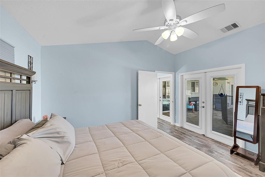 22533 Swordfish Drive Boca Raton, FL 33428 - Photo 19 of 49 a view of a bedroom with a large bed and a chandelier