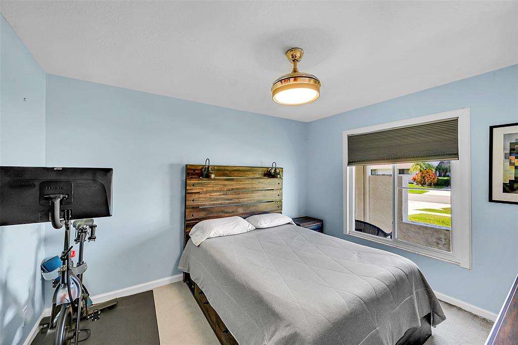 22533 Swordfish Drive Boca Raton, FL 33428 - Photo 23 of 49 a bedroom with a bed and a chandelier