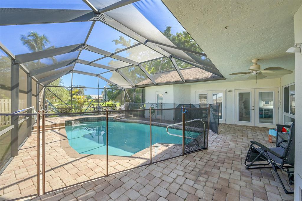 22533 Swordfish Drive Boca Raton, FL 33428 - Photo 29 of 49 a view of a patio with a table and chairs under an umbrella
