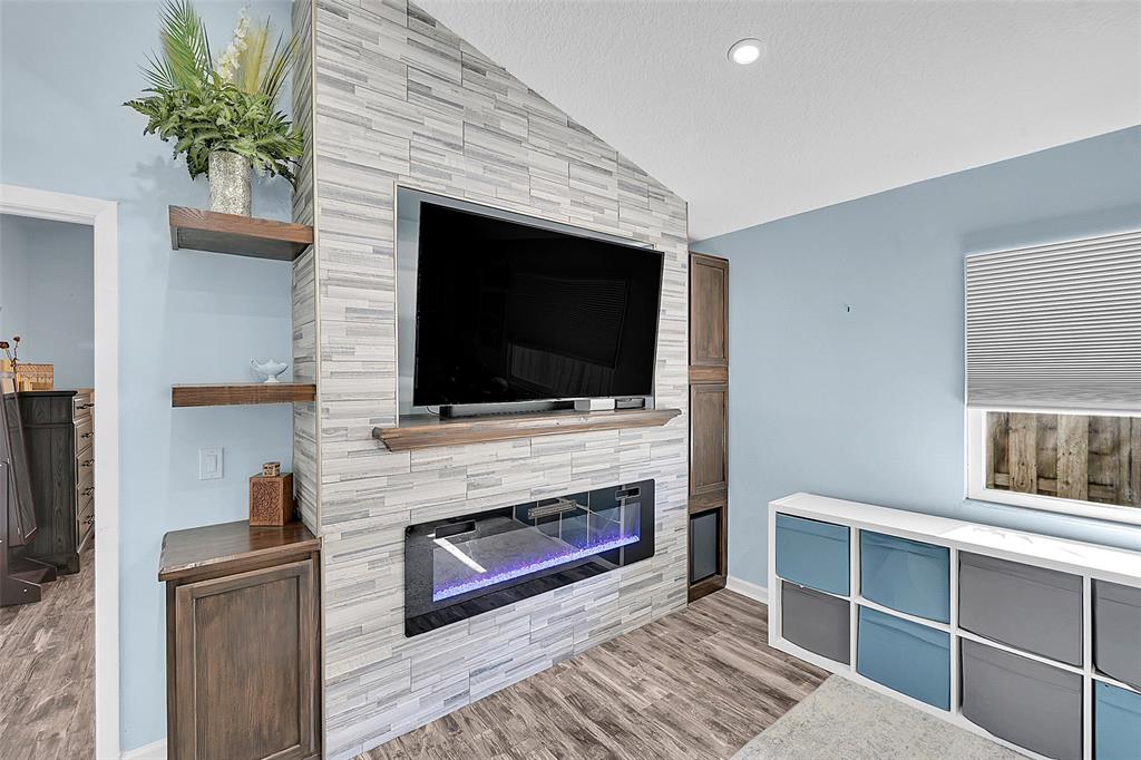 22533 Swordfish Drive Boca Raton, FL 33428 - Photo 6 of 49 a living room with a flat screen tv and a fireplace