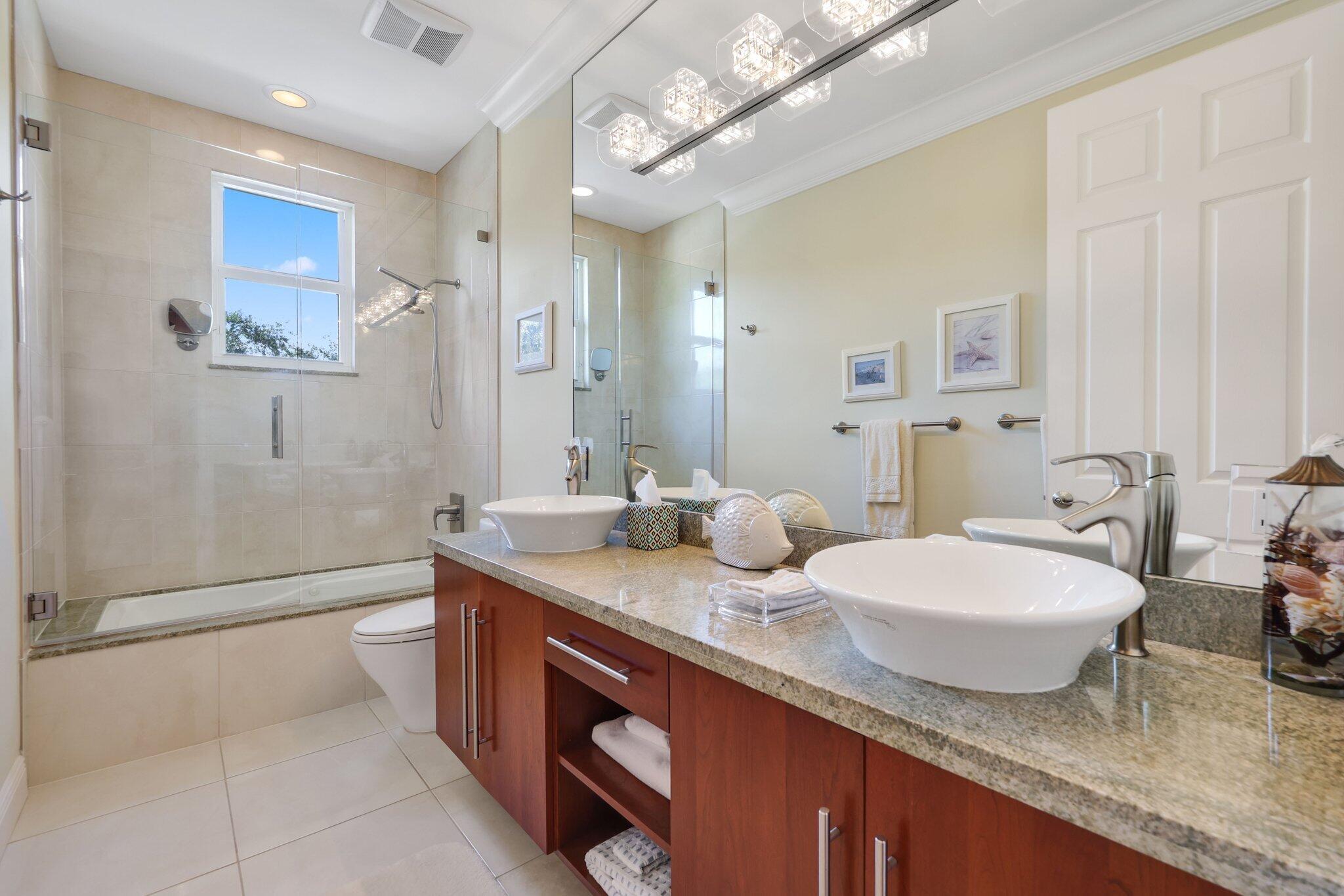 19245 Skyridge Circle Boca Raton, FL 33498 - Photo 46 of 70 a bathroom with a granite countertop sink a toilet a mirror and shower