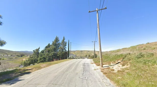 a view of a balcony with a yard