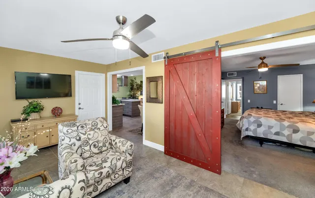 a bedroom with furniture and flat screen tv