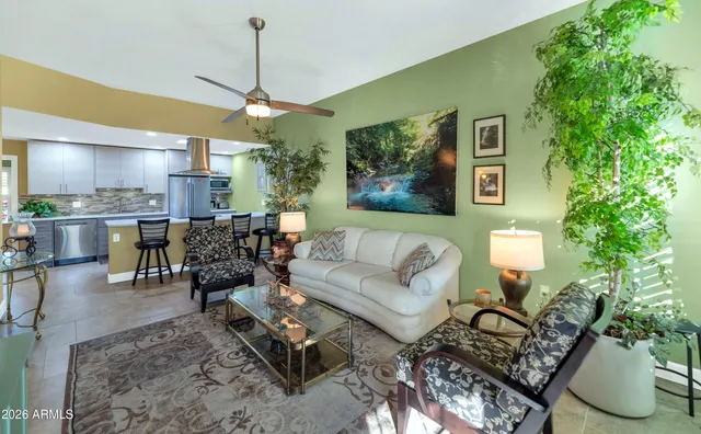 a living room with furniture and a chandelier
