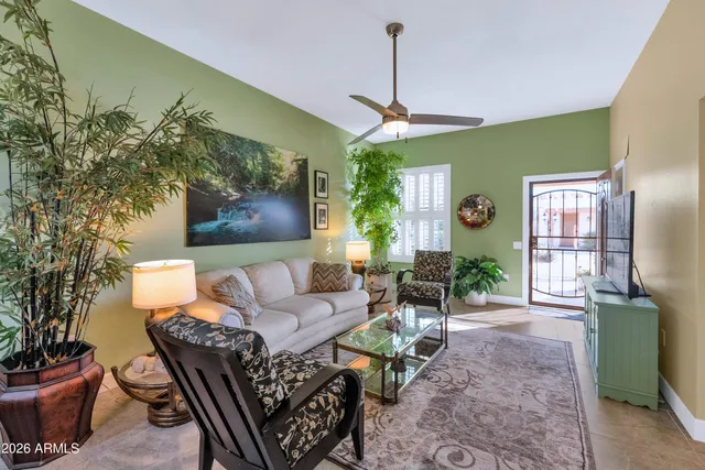 a living room with furniture and a chandelier