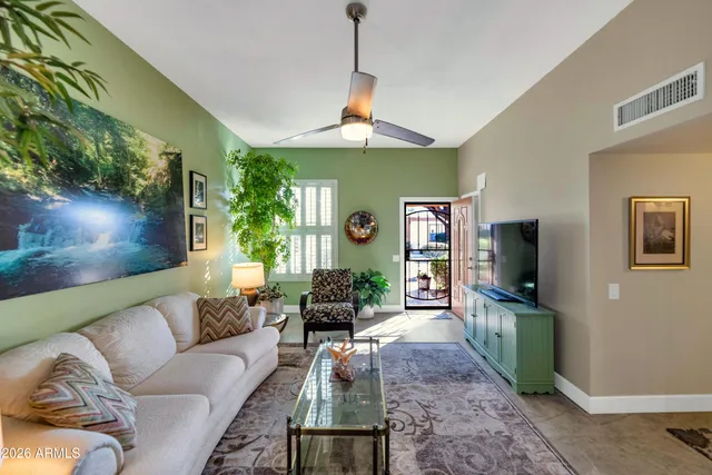 a living room with furniture and a flat screen tv