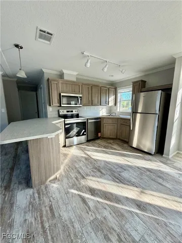 a kitchen with a sink appliances and cabinets