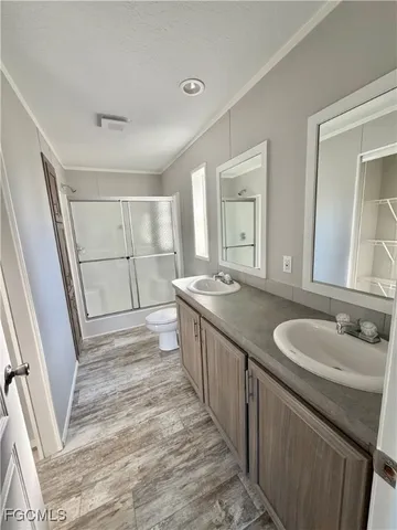 a bathroom with a double vanity sink and a mirror