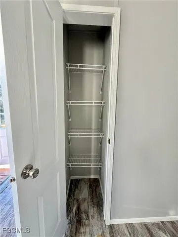 a room with a wooden door and a sink