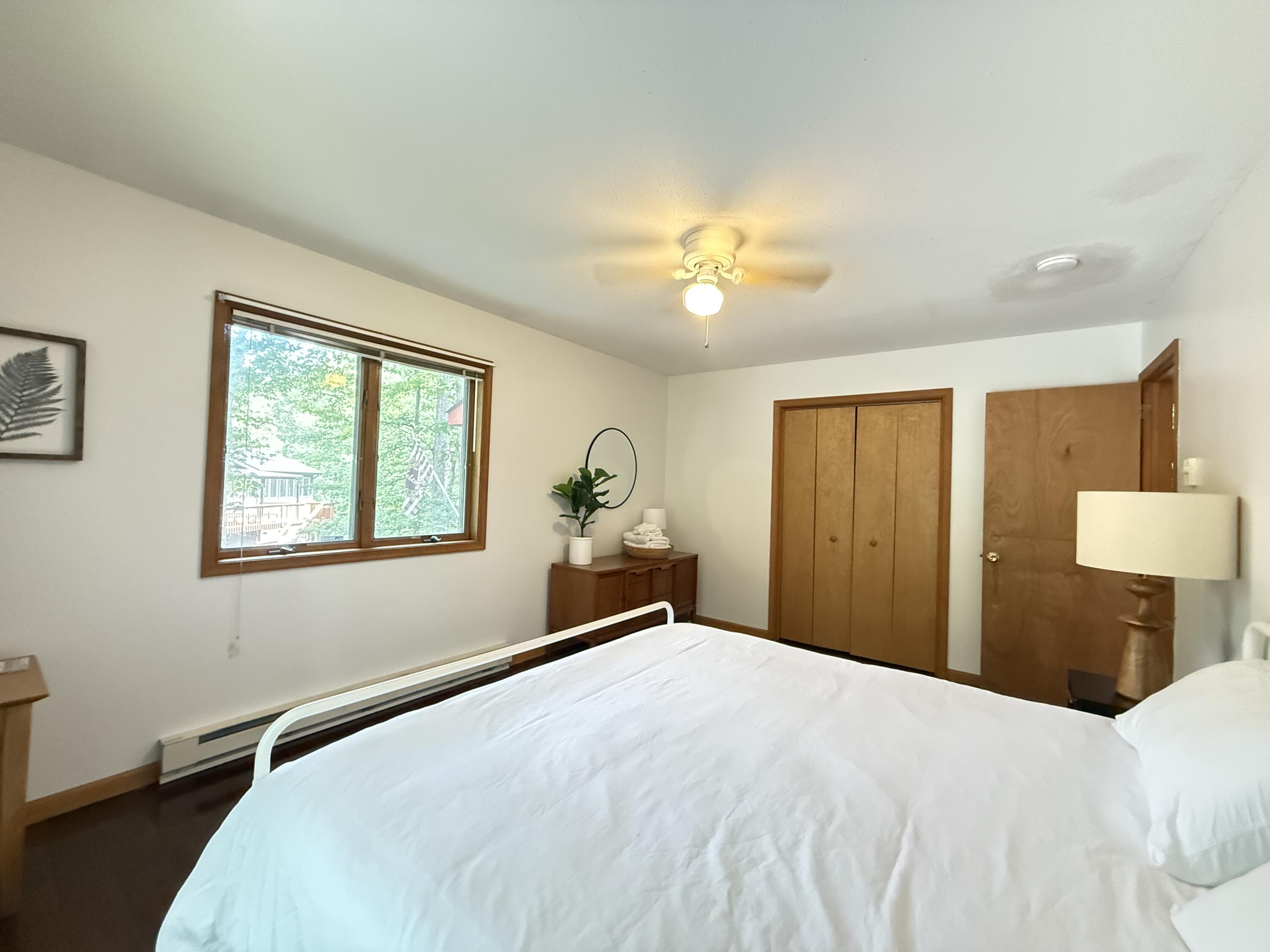 6414 Decker Road Bushkill, PA 18324 - Photo 22 of 65 a bedroom with a bed and a chandelier