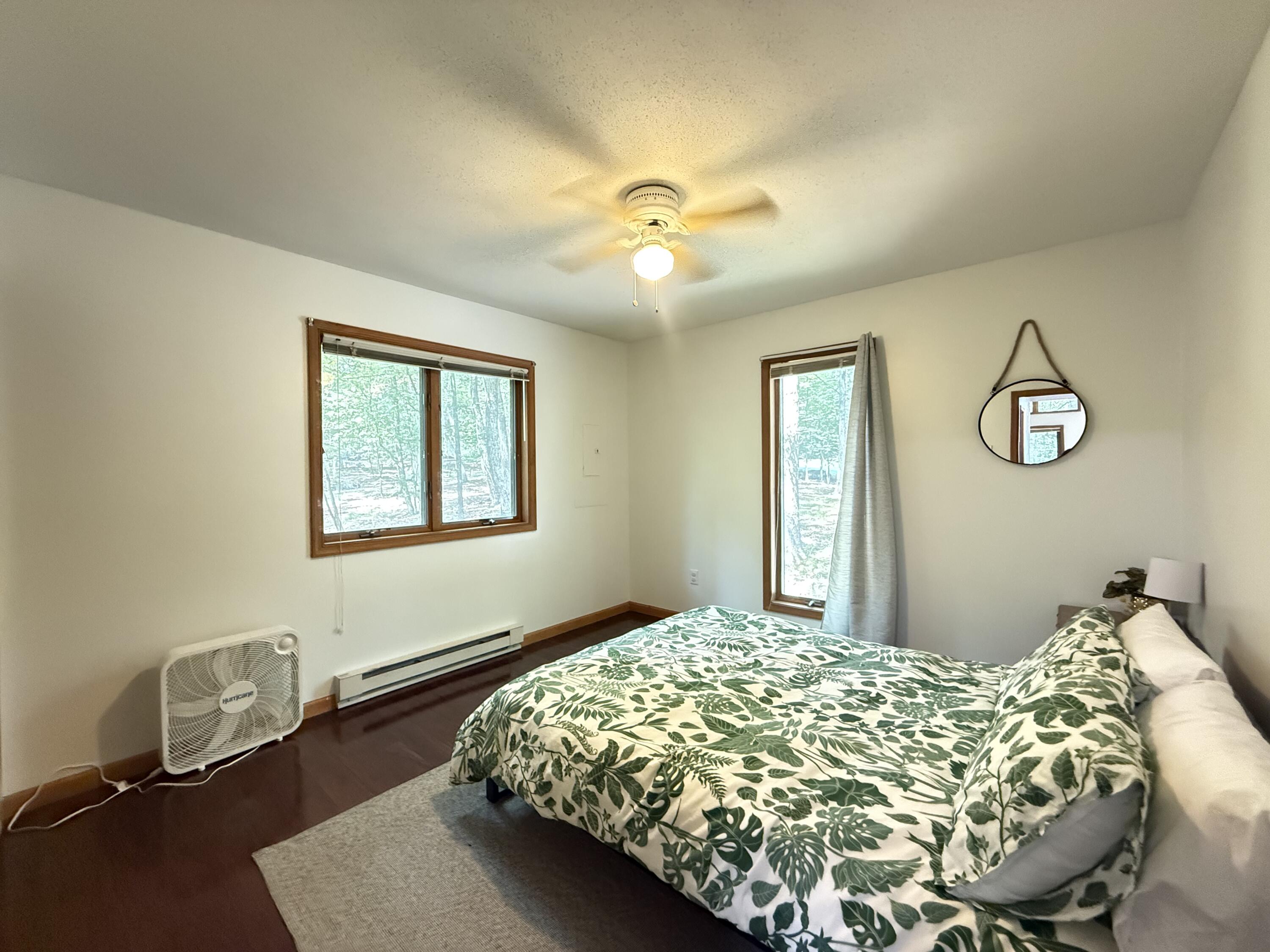 6414 Decker Road Bushkill, PA 18324 - Photo 23 of 65 a bed sitting in a bedroom next to a window and a chandelier