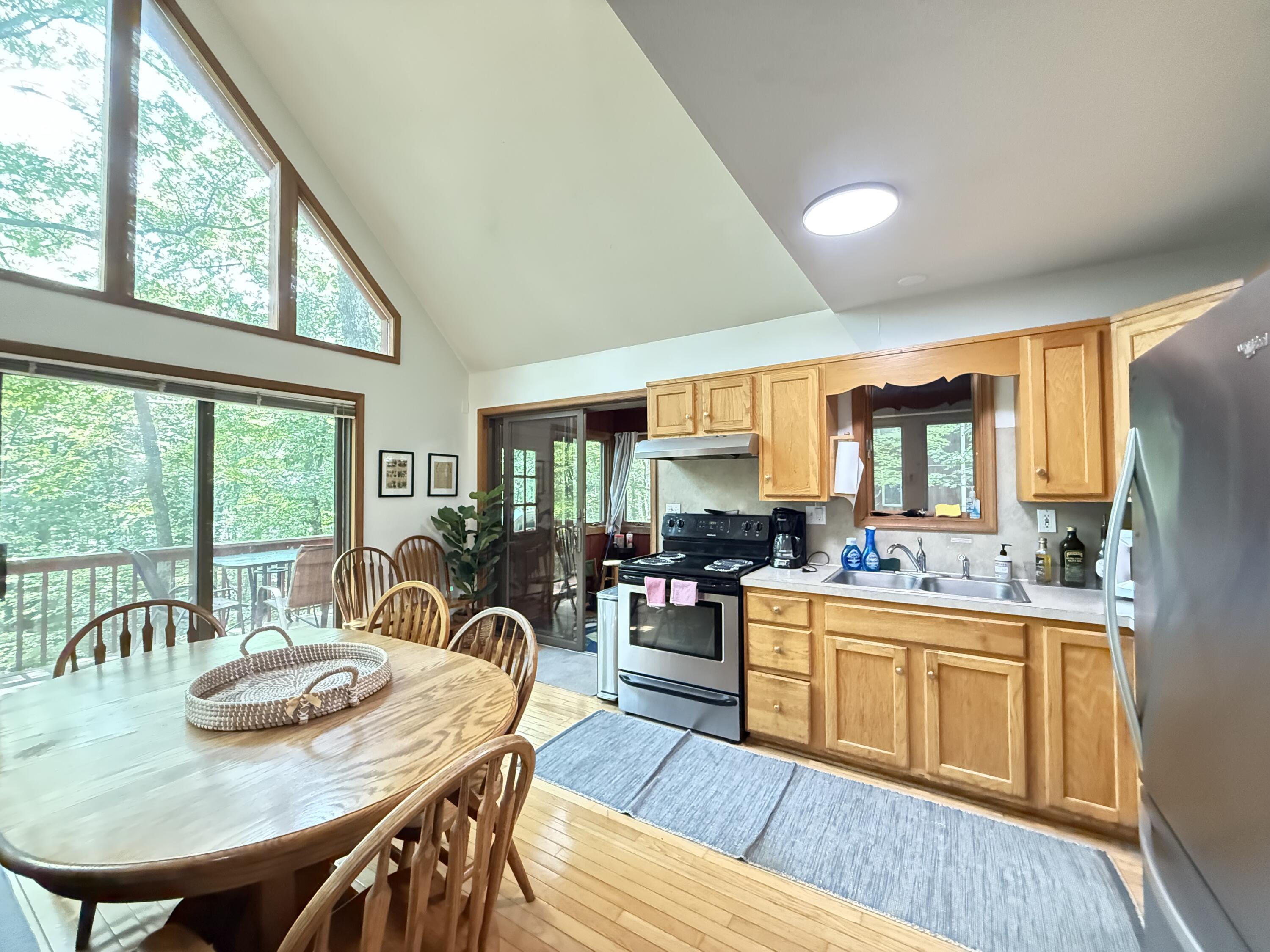 6414 Decker Road Bushkill, PA 18324 - Photo 10 of 65 a kitchen with a table chairs stove and wooden floor