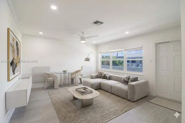 a living room with furniture and a large window