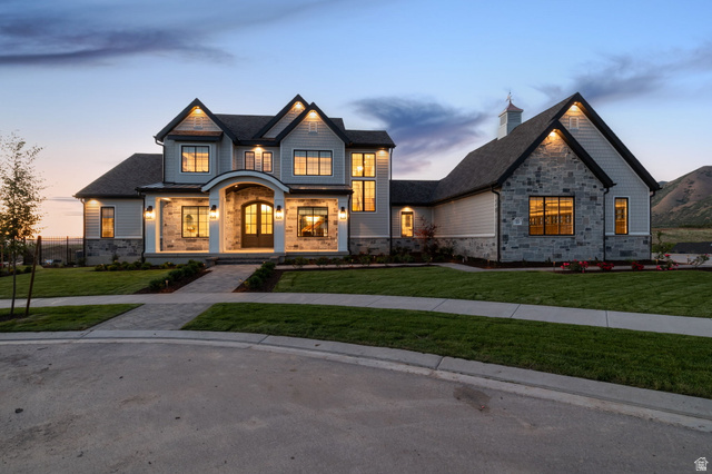 Beautiful exterior with stone and siding facade, an arched entry, and a cupola