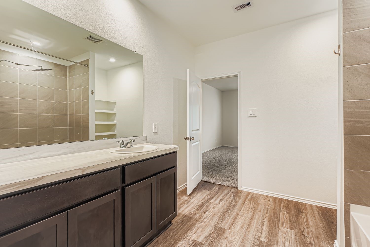 1726 Windstone Ridge Drive Houston, TX 77014 - Photo 14 of 28 a bathroom with a sink and a mirror