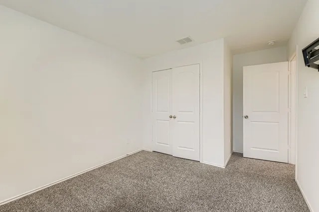 a bathroom with a granite countertop sink a toilet a mirror a bathtub and shower